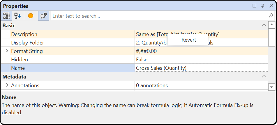Properties view with changed Description and Format String rows and the right-click Revert command